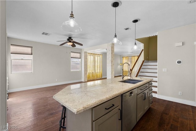 kitchen with a sink, visible vents, stainless steel dishwasher, and dark wood finished floors