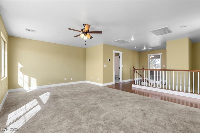 unfurnished room featuring visible vents, carpet, and ceiling fan