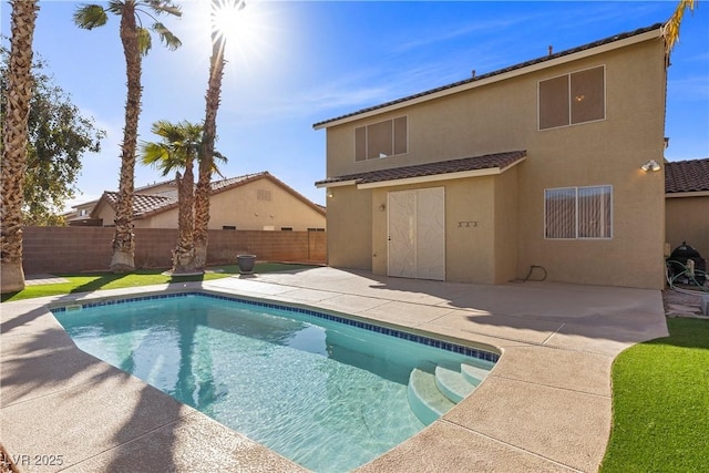 view of swimming pool with a patio area, a fenced in pool, and a fenced backyard