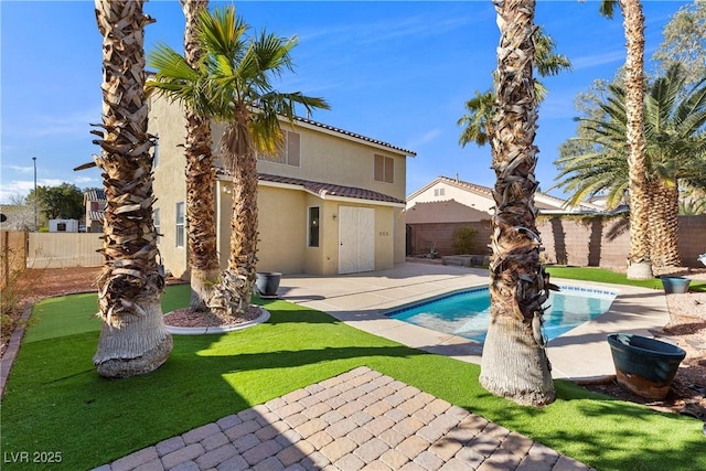 view of swimming pool with a patio, a yard, a fenced backyard, and a fenced in pool