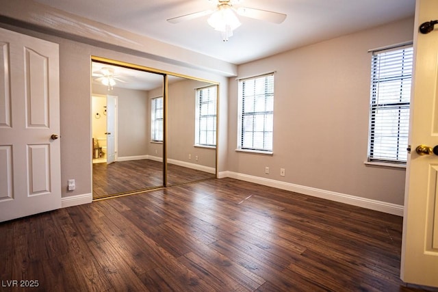 unfurnished bedroom featuring wood finished floors, baseboards, a closet, and ceiling fan