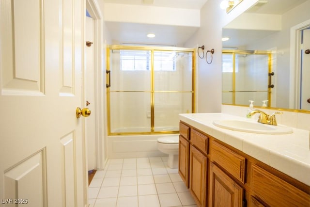 bathroom featuring enclosed tub / shower combo, toilet, vanity, and tile patterned flooring