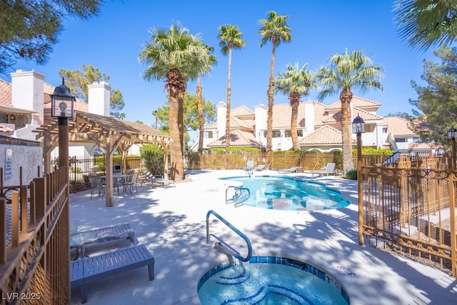 community pool featuring a residential view, a community hot tub, a patio, and fence