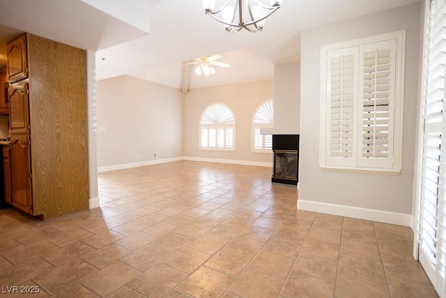 unfurnished living room featuring baseboards, a multi sided fireplace, lofted ceiling, light tile patterned floors, and ceiling fan with notable chandelier