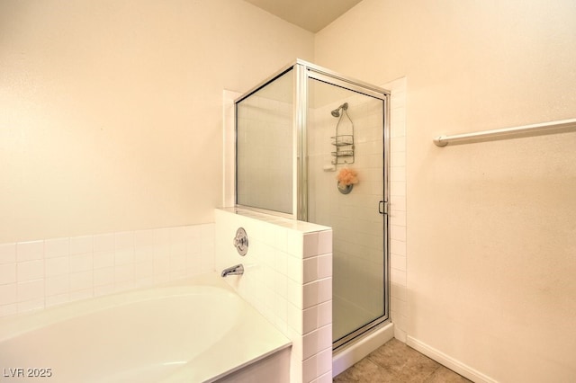 bathroom featuring a shower stall, a bath, and tile patterned floors