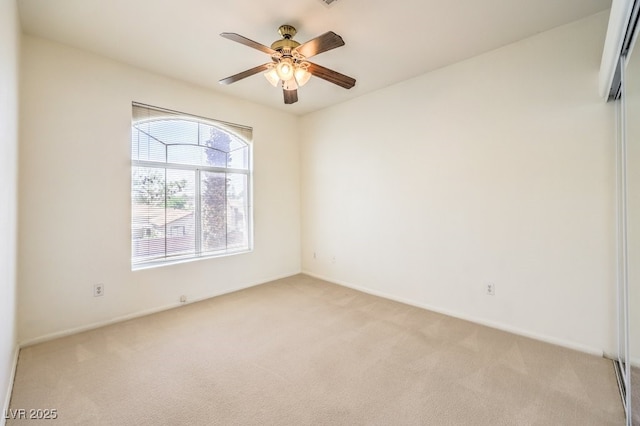 empty room featuring light carpet and ceiling fan