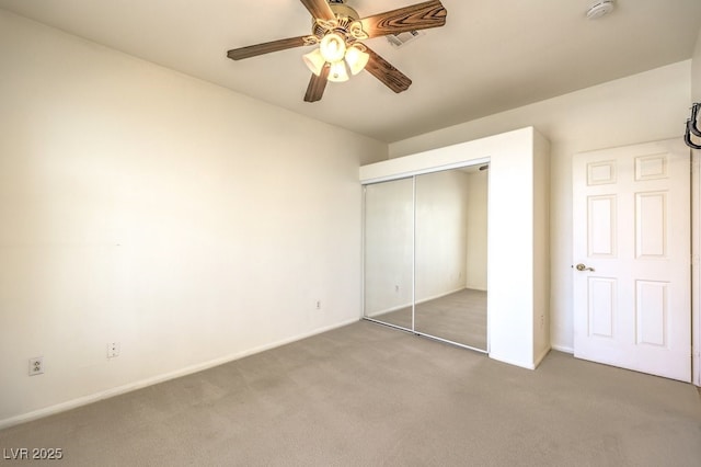 unfurnished bedroom featuring visible vents, a ceiling fan, a closet, carpet, and baseboards