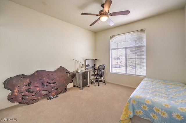 carpeted bedroom featuring baseboards and ceiling fan