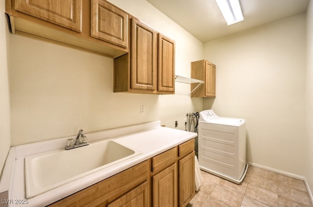 clothes washing area with washer / clothes dryer, cabinet space, baseboards, and a sink