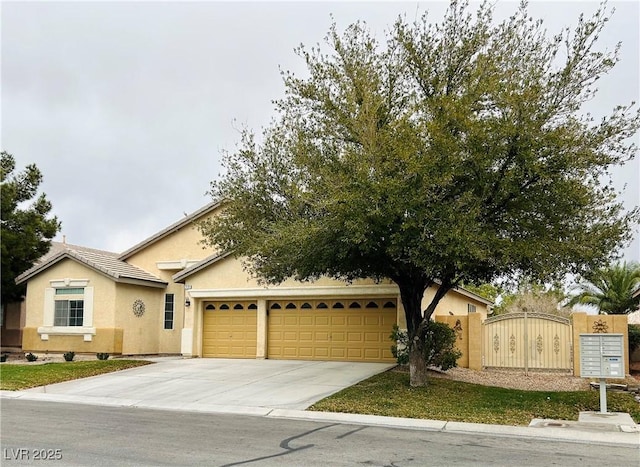 7172 Painted Paradise St, Las Vegas, NV 89131 - view of front of property featuring an attached garage, concrete driveway, stucco siding, and a gate