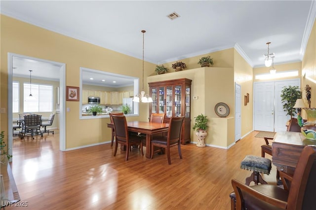 7172 Painted Paradise St, Las Vegas, NV 89131 - dining space with light wood-style floors, crown molding, and baseboards