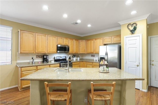 7172 Painted Paradise St, Las Vegas, NV 89131 - kitchen featuring appliances with stainless steel finishes, a sink, light brown cabinetry, ornamental molding, and a breakfast bar