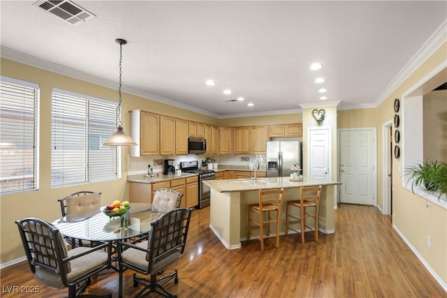 7172 Painted Paradise St, Las Vegas, NV 89131 - kitchen featuring appliances with stainless steel finishes, light brown cabinetry, wood finished floors, recessed lighting, and crown molding