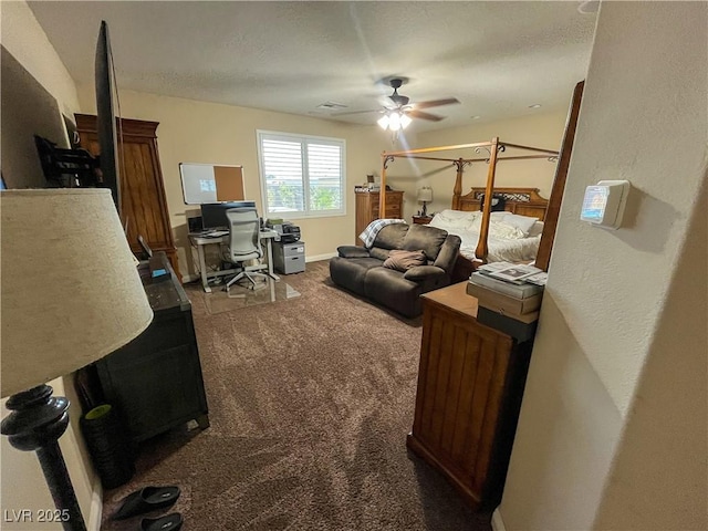 living room featuring visible vents, a ceiling fan, carpet flooring, and a textured ceiling