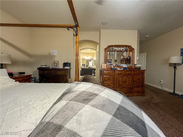 bedroom featuring arched walkways, baseboards, and carpet floors