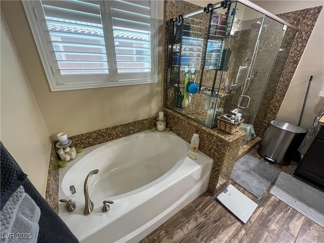 bathroom featuring a bath and a stall shower