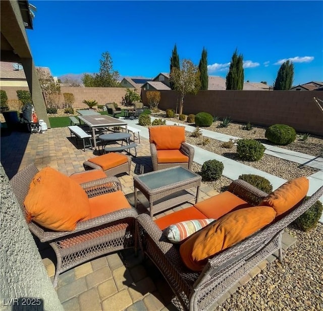 view of patio with outdoor dining area, a fenced backyard, and an outdoor hangout area