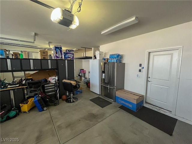 garage with stainless steel fridge with ice dispenser, a garage door opener, and white fridge with ice dispenser