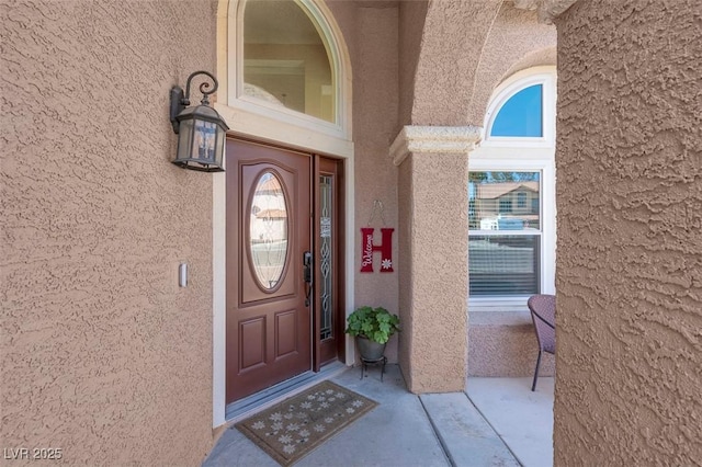 property entrance with stucco siding