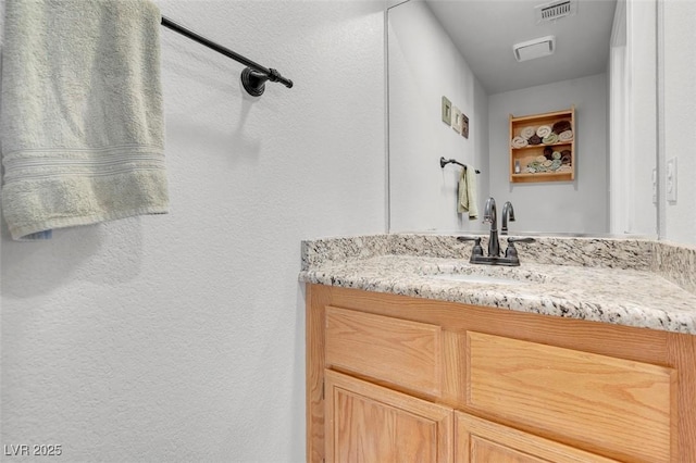 bathroom with visible vents and vanity