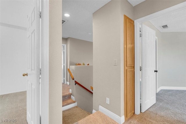 staircase featuring carpet flooring, recessed lighting, baseboards, and visible vents