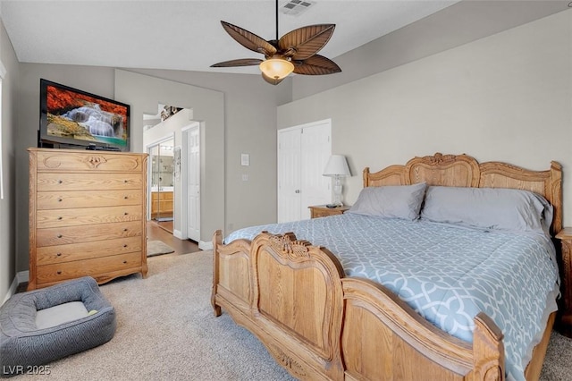 bedroom with visible vents, carpet floors, ensuite bathroom, a closet, and a ceiling fan