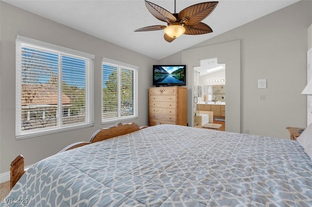 bedroom with ceiling fan, connected bathroom, baseboards, and vaulted ceiling