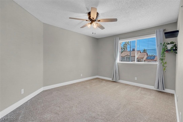 spare room featuring baseboards, carpet floors, and ceiling fan