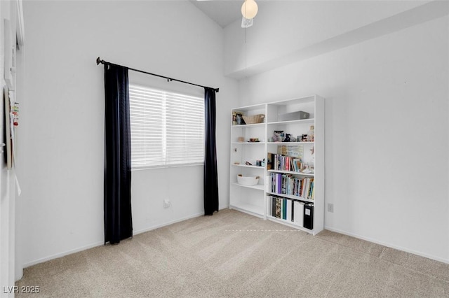 carpeted spare room featuring baseboards