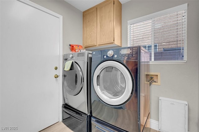 clothes washing area featuring cabinet space, light wood-type flooring, and independent washer and dryer