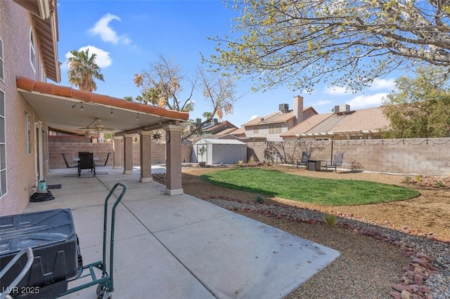 view of patio / terrace with a storage shed, a fenced backyard, and an outdoor structure