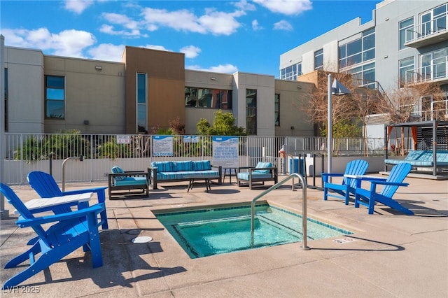 view of pool featuring a patio area, a hot tub, and fence