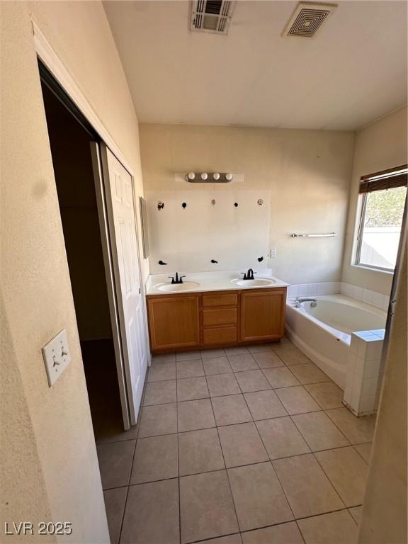 full bathroom featuring a sink, visible vents, and a bath