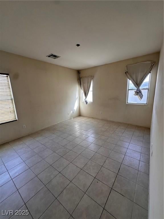 spare room with light tile patterned floors and visible vents