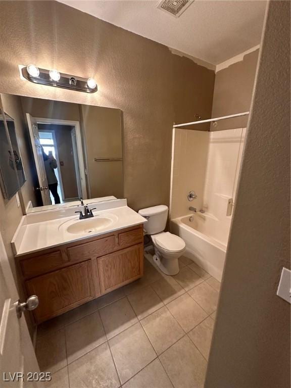 full bathroom with vanity, visible vents, tile patterned flooring, toilet, and a textured wall