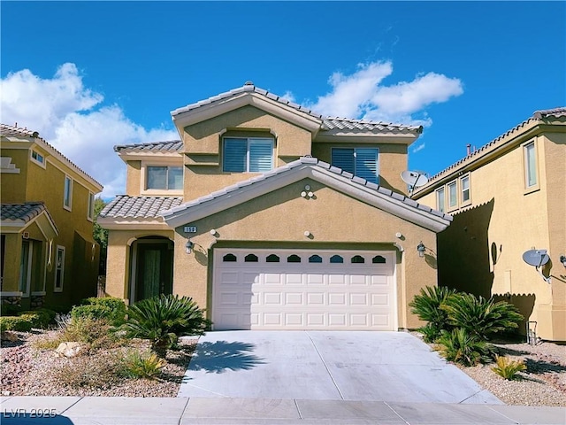 mediterranean / spanish-style house featuring a tile roof, stucco siding, an attached garage, and concrete driveway