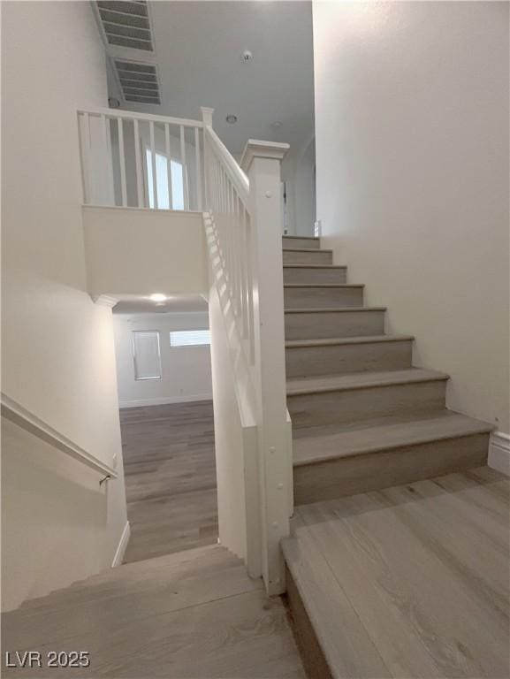 stairway featuring wood finished floors