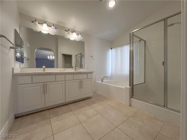 full bath with a stall shower, a garden tub, and a sink