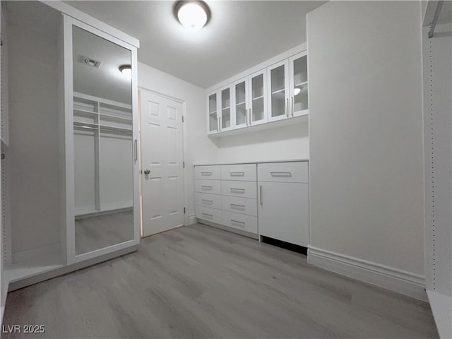 walk in closet with light wood-style floors and visible vents