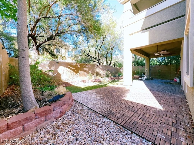 view of patio with a fenced backyard and ceiling fan