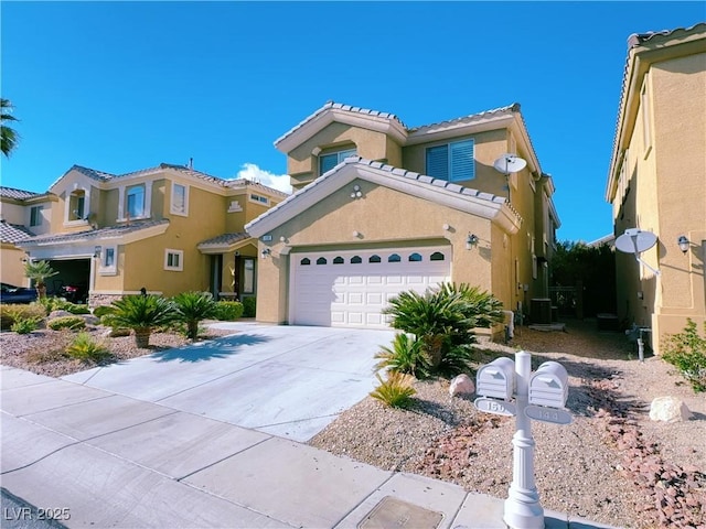 mediterranean / spanish house with stucco siding, driveway, an attached garage, and a tiled roof