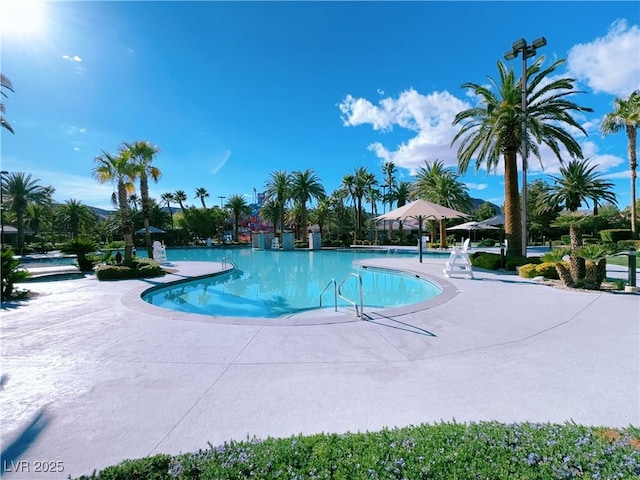 community pool with a patio area