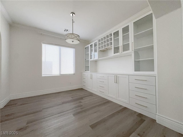 150 Short Ruff Way, Las Vegas, NV 89148 - unfurnished dining area featuring crown molding, baseboards, wood finished floors, and visible vents