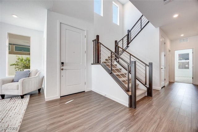 entrance foyer featuring visible vents, light wood finished floors, plenty of natural light, and recessed lighting