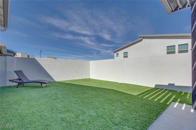 view of yard with a fenced backyard