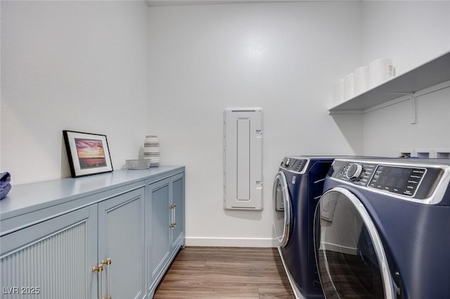 laundry area with washer and dryer, wood finished floors, baseboards, and cabinet space