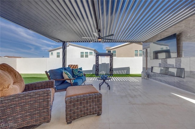 view of patio / terrace with outdoor lounge area, fence, and a ceiling fan