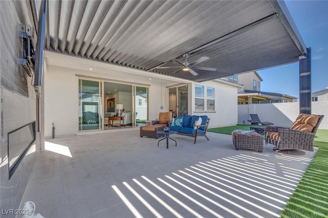 view of patio / terrace with an outdoor living space, fence, and ceiling fan