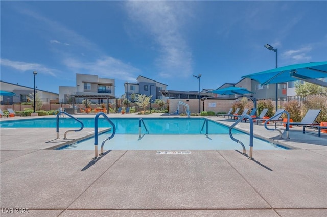 pool featuring a patio and fence