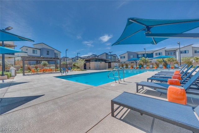 pool featuring a residential view, fence, a patio, and a pergola